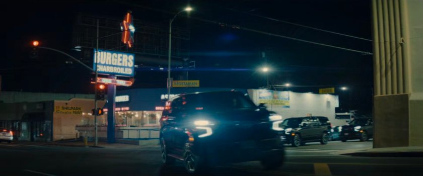 DODC SUVs race around a street corner by Astroburger.