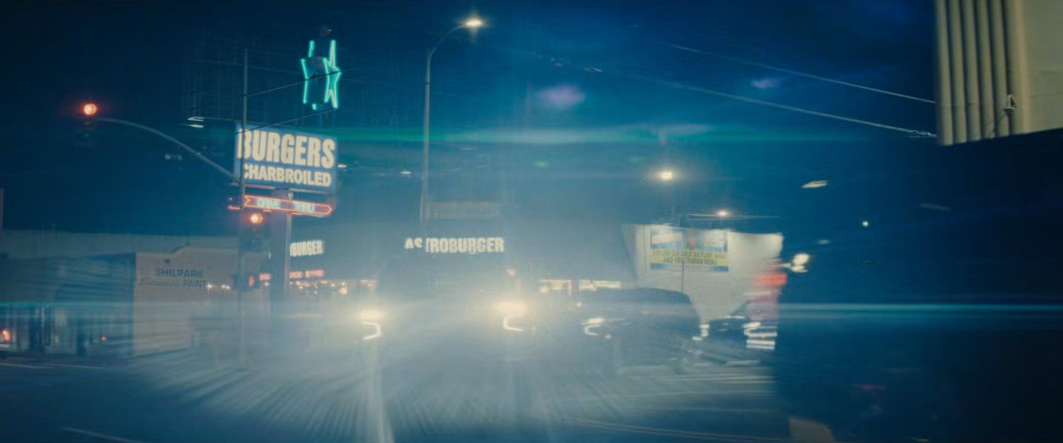 DODC SUVs race around a street corner by Astroburger.