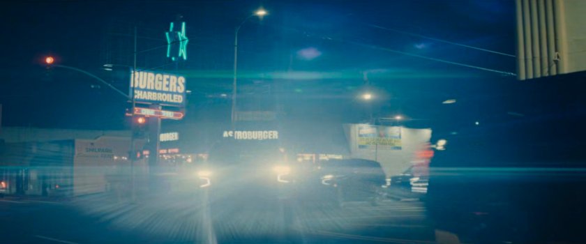 DODC SUVs race around a street corner by Astroburger.