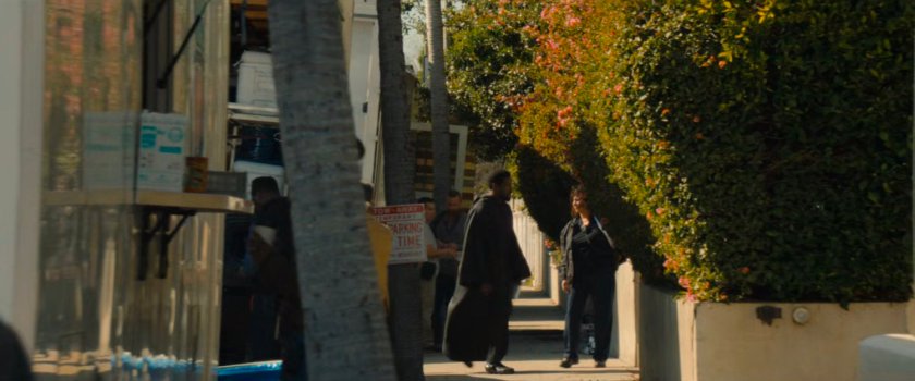 Simon crossing a sidewalk to the Wonder Man filming house.