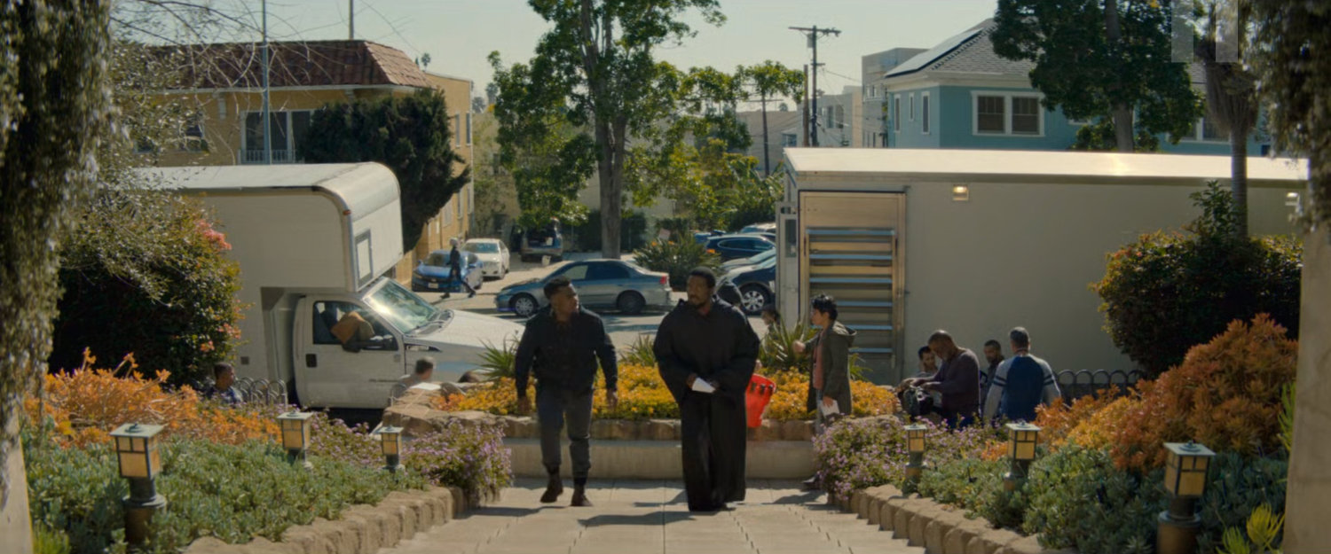 Simon walking up a stairway to the Wonder Man filming house.