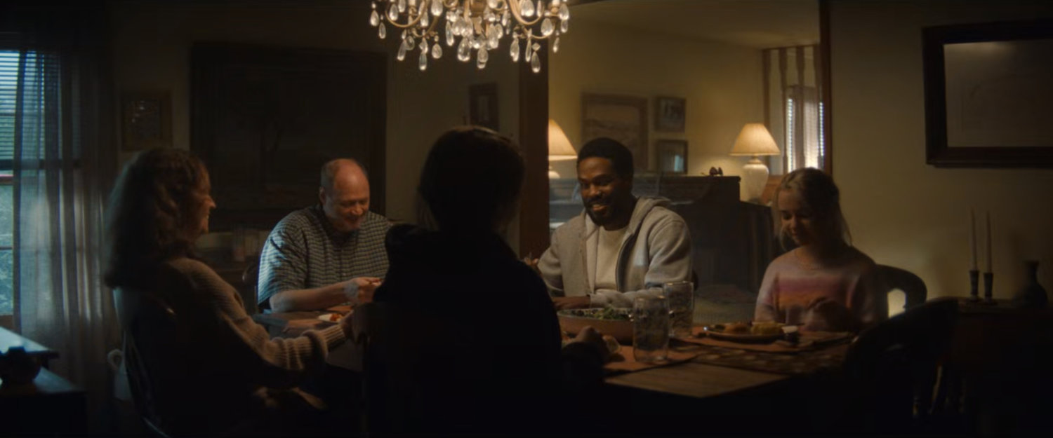 Simon joins the Eastman's for dinner in their house.