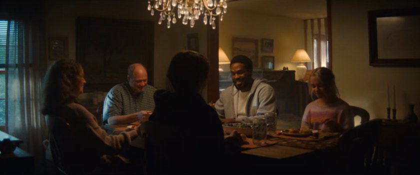 Simon joins the Eastman's for dinner in their house.