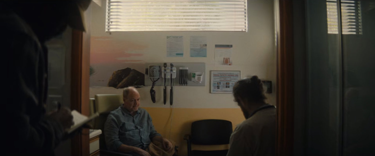 Simon observes Chuck's medical checkup.