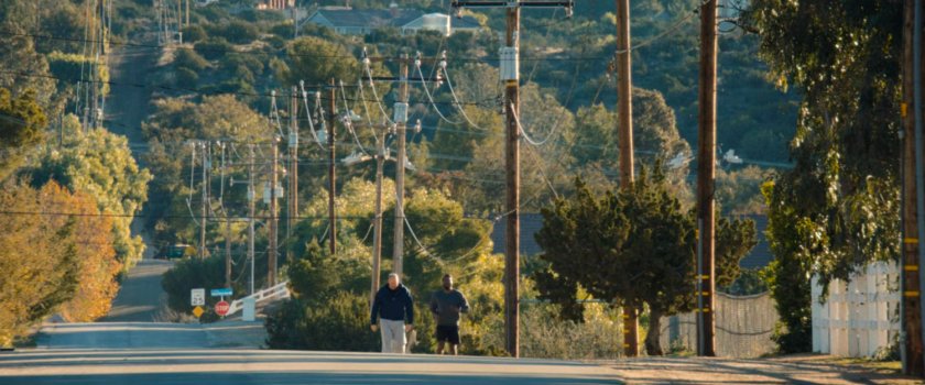 Simon and Chuck jogging on a road in Yucca Valley.