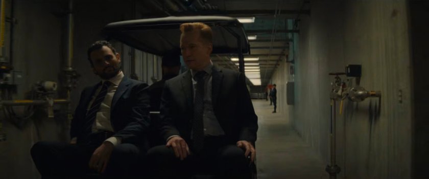 Agent Cleary and Deputy Secretary Heyerdahl on a golf cart in a DODC Supermax hallway.