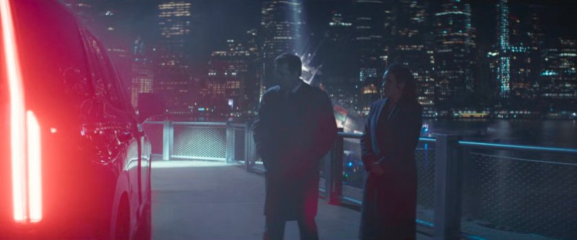Daniel and Sheila outside the Mayor's SUV on an East River pier at night.