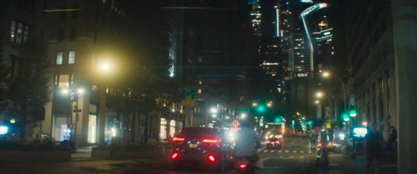 Interstitial: Cars on a New York street at night.