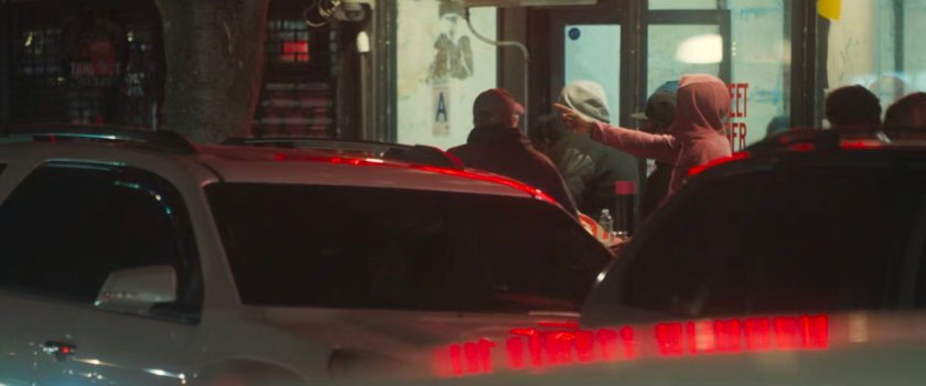 Interstitial: Pedestrians on a sidewalk at night.