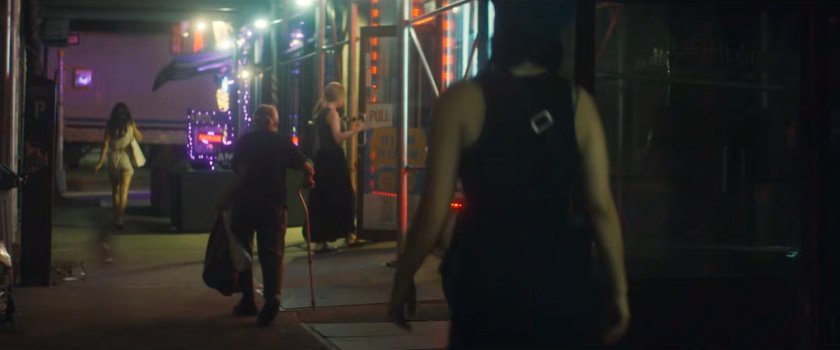 Interstitial: Pedestrians on a sidewalk at night.