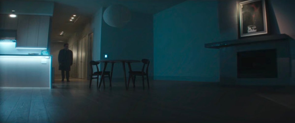 Daniel in his clean and empty apartment.