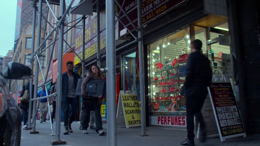 Malcolm following Inez along a sidewalk.