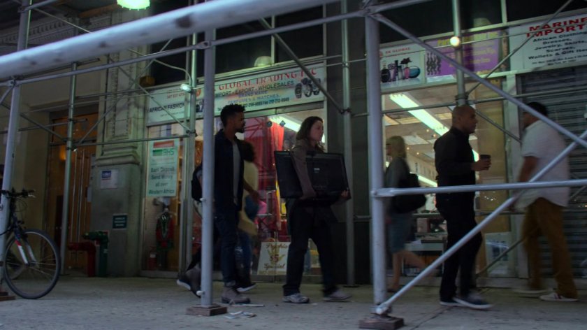 Malcolm following Inez along a sidewalk.