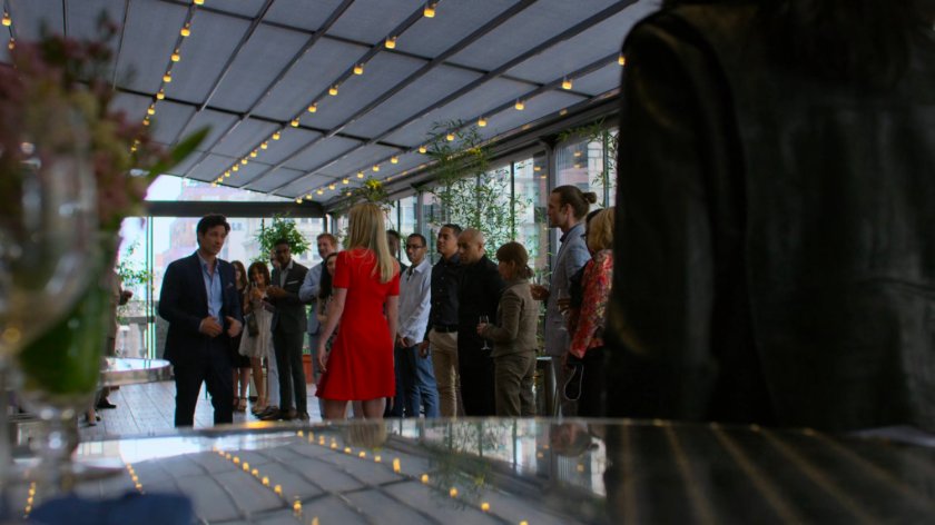 Griffin and Trish (and guests) inside of a rooftop restaurant.