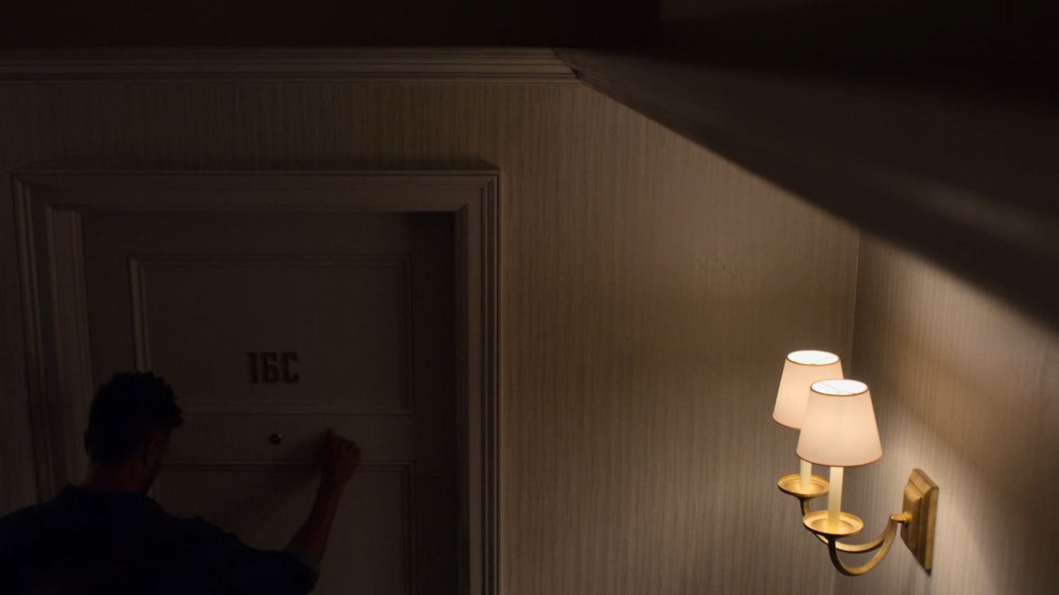Malcolm knocking on Jeri's apartment.