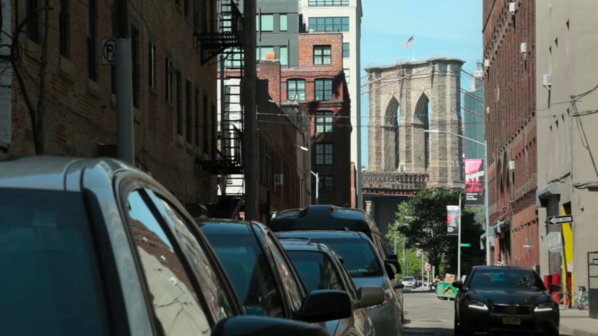 View of Brooklyn Bridge along a street in Brooklyn.