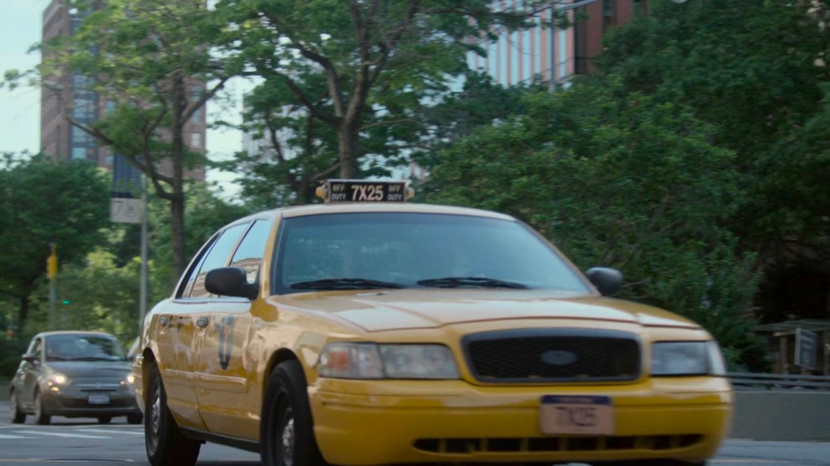 Cab driving along New York street.