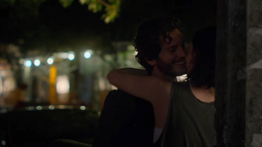 Jessica and Stirling hugging on a dark sidewalk.