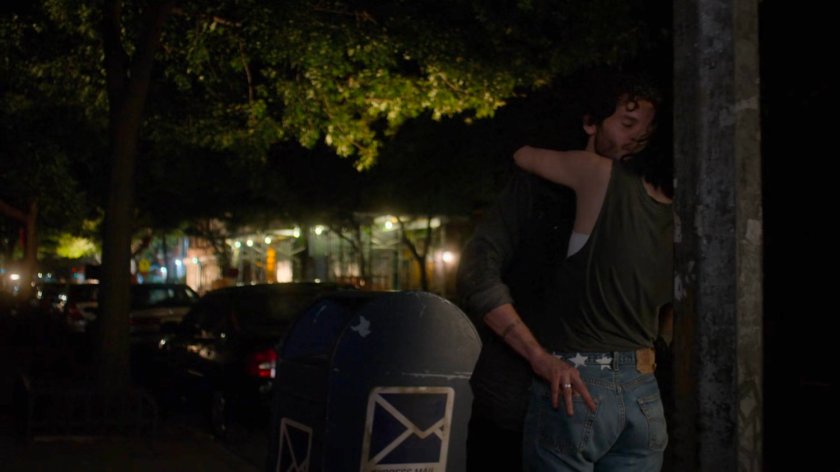 Jessica and Stirling hugging on a dark sidewalk.