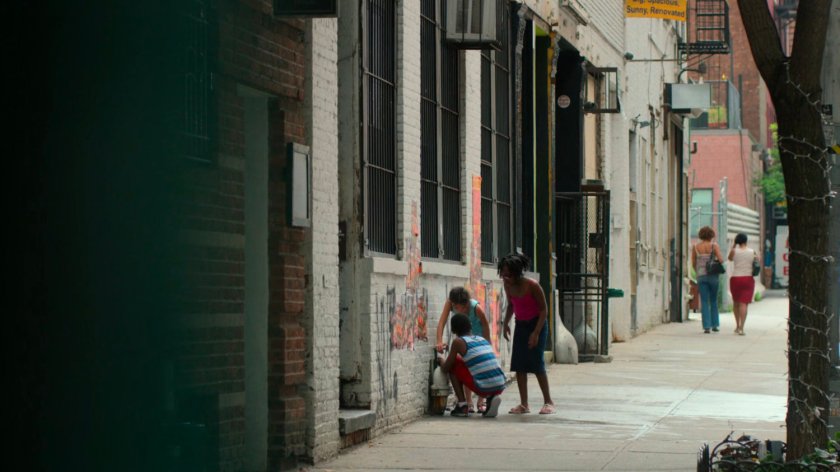 Kids play in the water outside Jessica and Stirling's loft.