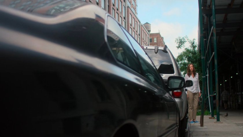 Alisa walking on the sidewalk outside Jessica and Stirling's loft.