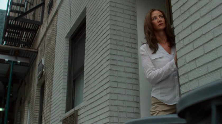 Alisa spying from the sidewalk outside Jessica and Stirling's loft.