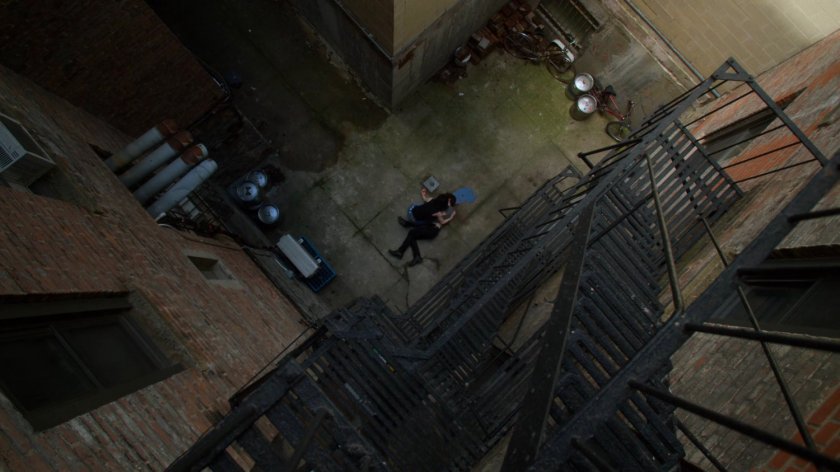 Jessica cradles Stirling in an alley behind the Phoenix Bar.