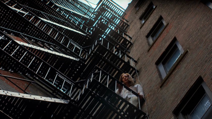 Alisa on a fire escape in an alley behind the Phoenix Bar.