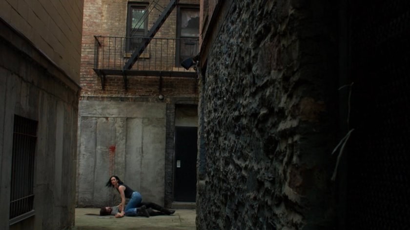 Jessica cradles Stirling in an alley behind the Phoenix Bar.