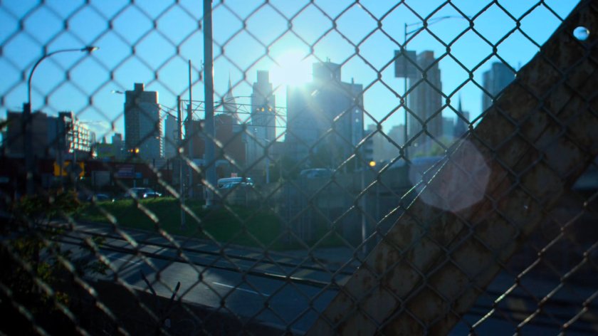 New York City as seen through a chain link fence.