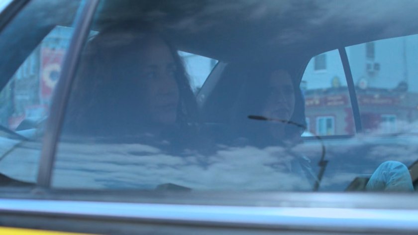 Jessica and Alisa in the back seat of a cab.