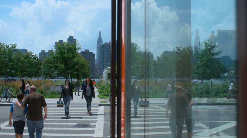 Jessica and Alisa crossing a street in front of a park.