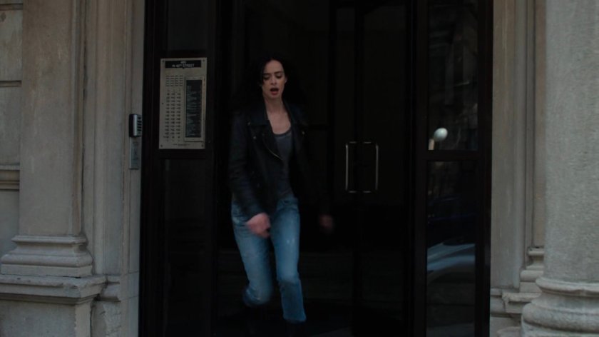 Jessica exiting her apartment building.