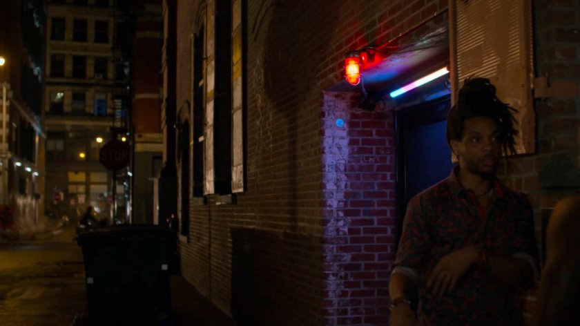 Exterior entrance to Whiskers bar at night.