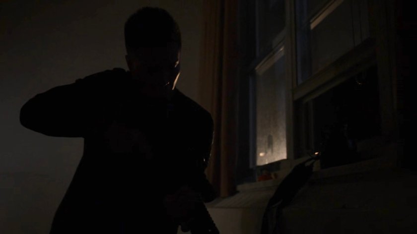 Pryce Cheng in an apartment with sniper rifle.