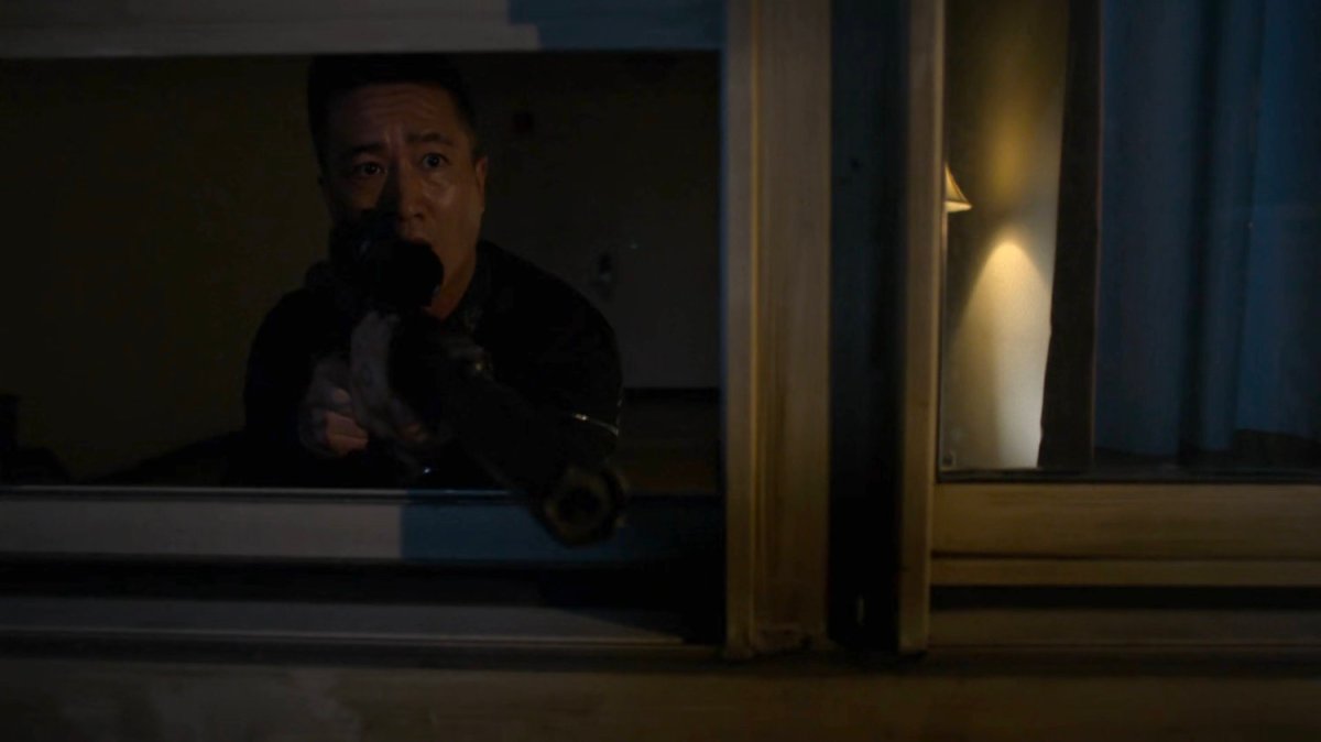 Pryce Cheng in an apartment with sniper rifle.