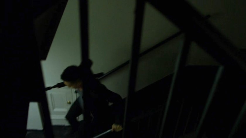 Pryce Cheng running through an apartment stairway.