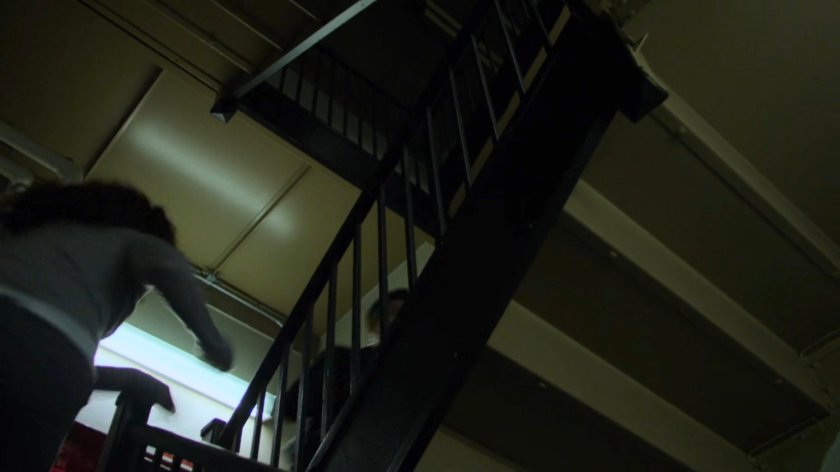 Pryce Cheng running through an apartment stairway.