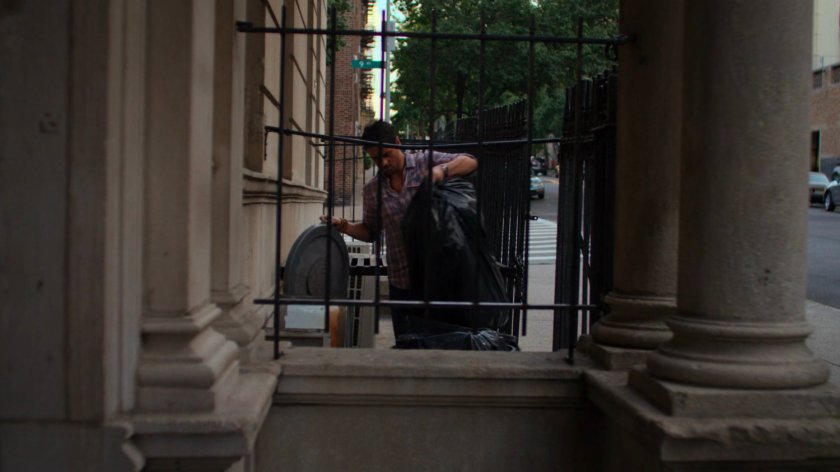 Oscar dumping trash outside Alias Investigations.