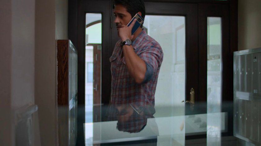 Oscar on the phone outside Sonia's Apartment.