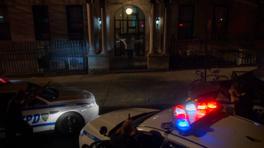 Alisa exiting lobby of Alias Investigations building with police outside.