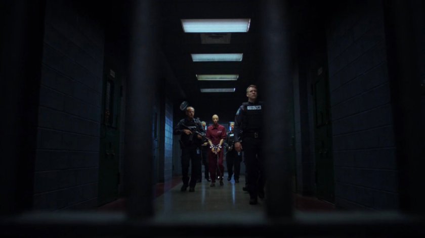 Alisa being escorted through the hallway of Eastern Regional Detention Center by guards.