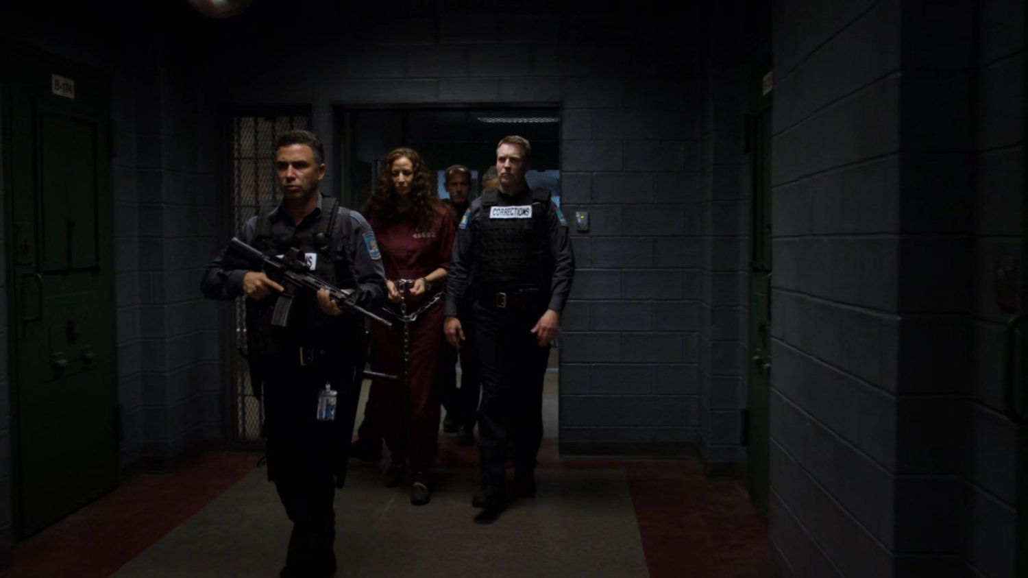 Alisa being escorted through the hallway of Eastern Regional Detention Center by guards.