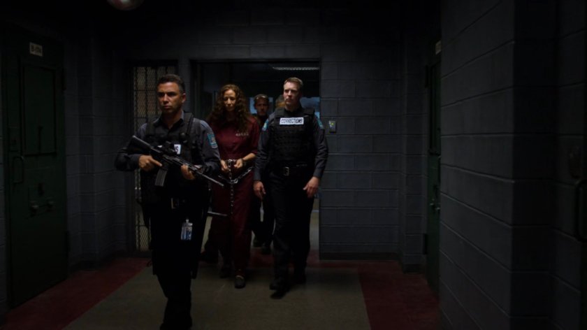 Alisa being escorted through the hallway of Eastern Regional Detention Center by guards.