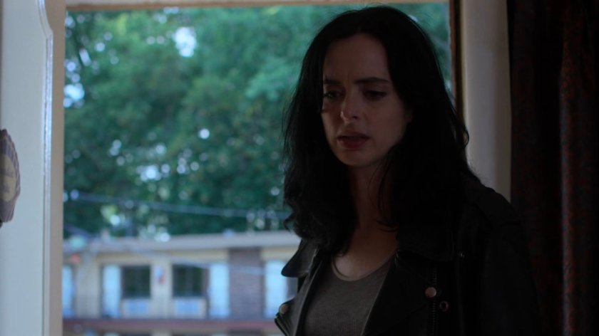 Jessica entering a room at the Love by the Sea Motel.