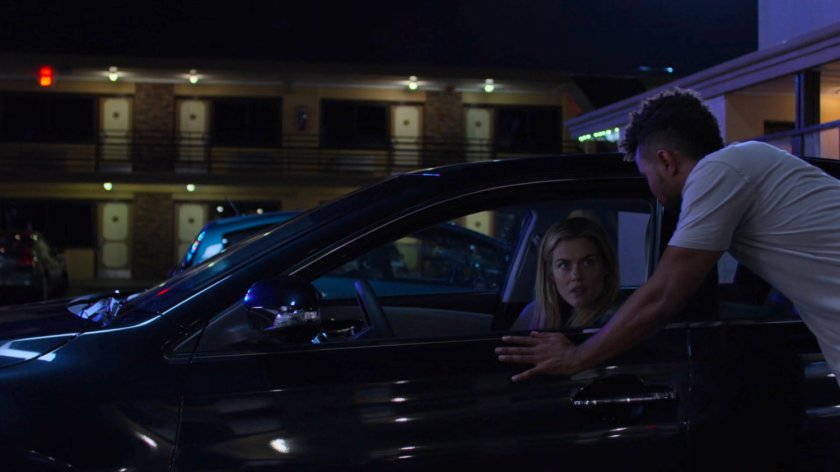 Trish and Malcolm in the parking lot at the Love by the Sea Motel.