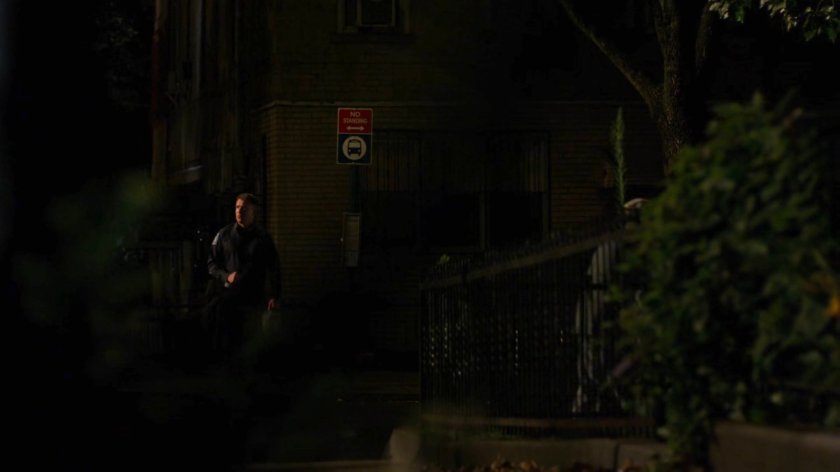 Holiday walking on the sidewalk outside his house.