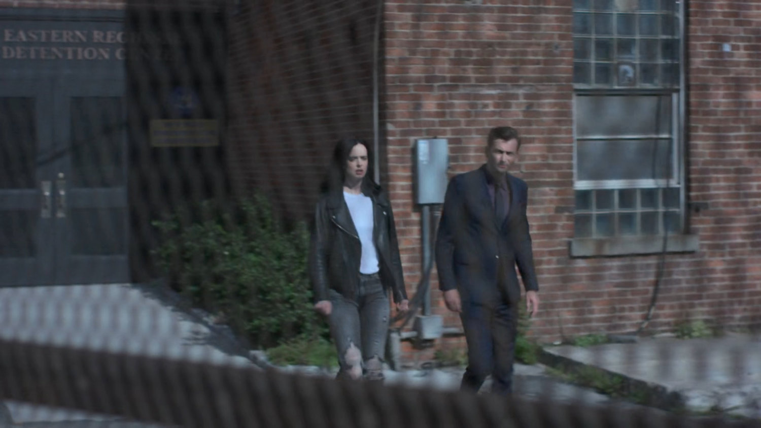 Jessica and Kilgrave walking outside Eastern Regional Detention Center.