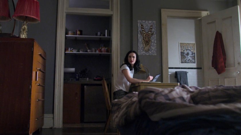 Jessica in Malcolm's apartment.