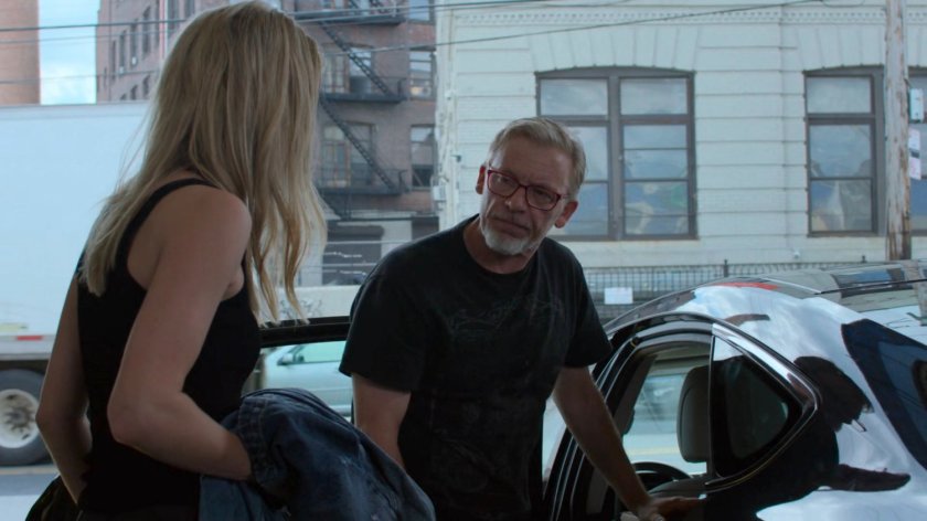 Trish and Karl getting into a car at a storage facility.